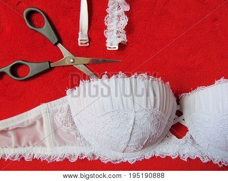 White lace strapless bra with scissors cutting the straps
