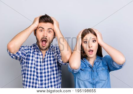 Really?! Two Young Shocked Lovers Are Amazed With Wide Open Eyes, Mouthes, Holding Heads, In A Casua