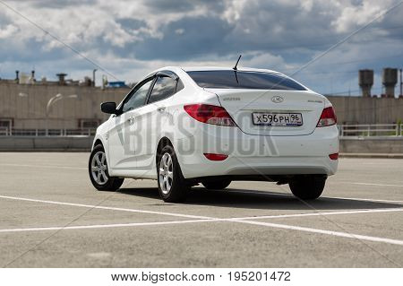 Ekaterinburg Russia July 03 2017 - Hyundai Solaris car (Accent) in a shopping center parking on a cloudy day