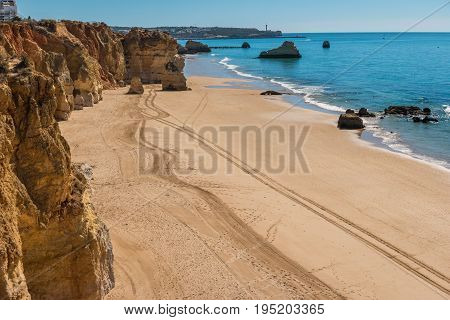 Scenic golden cliffs near Alvor Portimao. This beach is a part of famous tourist region Algarve