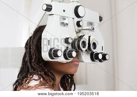 Close-up Of A Girl Doing Eye Test On Phoropter