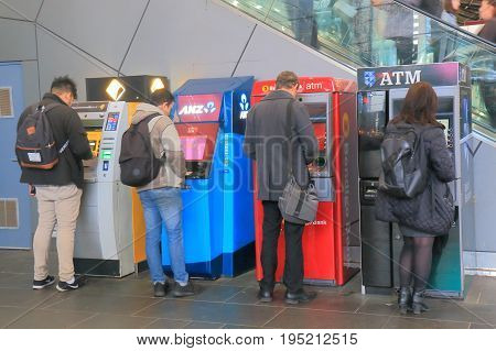 MELBOURNE AUSTRALIA - JULY 2, 2017: Unidentified people use ATM in Melbourne.