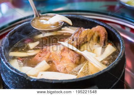 tibetan delicious food in stone pot to boil chicken with some wild fungus mushroom