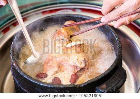 tibetan delicious food in stone pot to boil chicken with some wild fungus mushroom