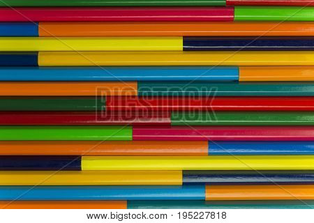Collection of coloured pencils in a horizontal complementary colors set up as background picture