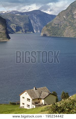Traditional norwegian fjord landscape with old wooden houses. Travel Norway