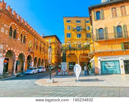 Verona, Italy - September 22, 2014: The Scaligeri Castle wall in Verona street and market view with Lamberti tower, tourist destination in Veneto region of Italy at September 22, 2014