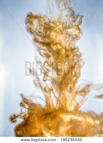 Ink swirl in a water on white background. The paint splash in the water. Soft dissemination a droplets of colored ink in water close-up. Abstract background. Explosion of color splashes acrylic ink.