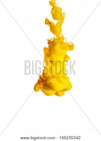 Ink swirl in water isolated on white background. The paint in the water. Soft dissemination a droplets of colored ink in water close-up. Abstract background. Explosion of splashes yellow acrylic ink.