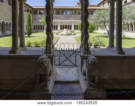 Basilica di San Giovanni in Laterano (St. John Lateran basilica). Details of Inner patio surrounded by beautiful twisted columns of inlaid marble. Italy Rome June 2017