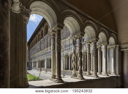 Basilica di San Giovanni in Laterano (St. John Lateran basilica). Inner patio surrounded by graceful twisted columns of inlaid marble. Italy Rome June 2017