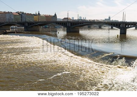 Old Town Prague Czech stone bridge over the turbulent river threshold on the Vltava