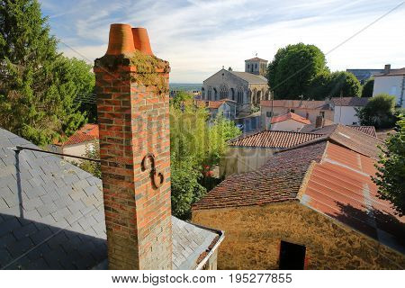 Roofs of traditional houses with St Jacques Church in the background, Pouzauges, Vendee, France