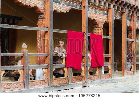 Trongsa Bhutan - September 12 2016: Happy Bhutanese man watching the backtyard of Trongsa Dzong Bhutan