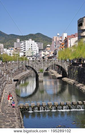 Nagasaki, Japan - April 6, 2014:Megane Bridge or Spectacles Bridge is an old stone arch bridge constructed over the Nakashima River in Nagasaki, Kyushu, Japan. The bridge was originally built in 1634.