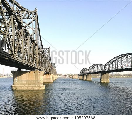 China - North Korea Friendship bridge (left); and the Broken Bridge (right), across the Yalu river. Taken in April, 2017, from public area in Dandong, Liaoning China, opposite to Sinuiju city, DPRK.