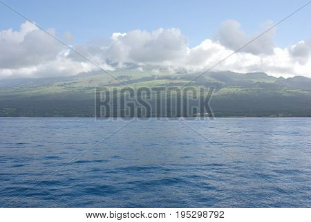 View of Maui with Molokini Crater. Molokini is popular for scuba diving and snorkeling