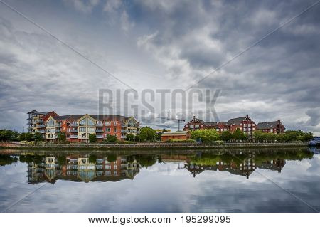 dramatic sky over modern appartaments blocks Greggs Quay and Laganview Court along river Lagan in Belfast, Northern Ireland, UK