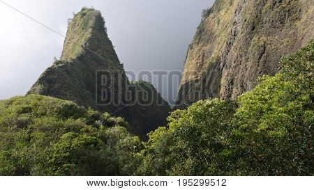View of West Maui Mountains in the Ioa Valley reach into the clouds. Maui is one of many popular Hawaiian tourist destinations.