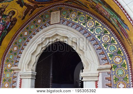 Decorated arch and mosaic over the entrance of the church