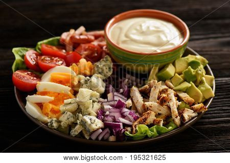 Salad cobb- avocado, tomatoes, bacon, chicken and onion.