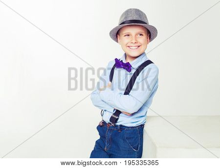 happy stylish boy wearing a hat, isolated against white background