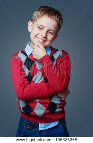happy thoughtful boy isolated against grey background