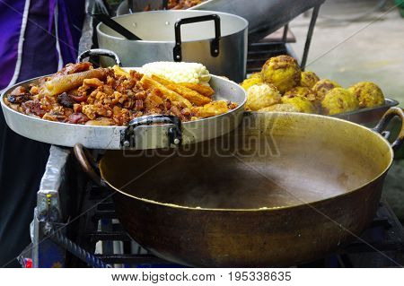 Close up of hornado roasted pork with a corn, ecuadorian traditional typical andean food over a tray .