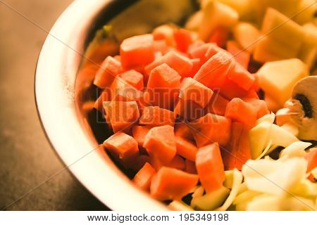 Freshly chopped carrots and vegetables ready to be cooked.