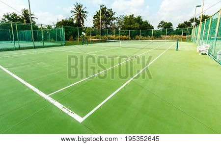 Outdoor tennis court, no green grass field.