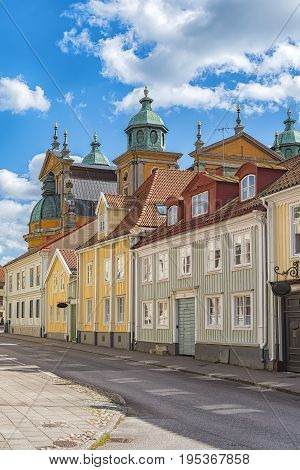 One of the streets in the Swedish town of Kalmar close to the cathedral which can be seen in the background behind the houses.