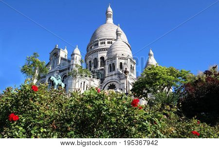 The basilica Sacre Coeur is a Roman catholic church located at the summet of the butte Montmartre , the highest point in Paris.