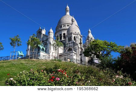 The basilica Sacre Coeur is a Roman catholic church located at the summet of the butte Montmartre , the highest point in Paris.