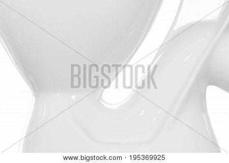 Part of white toilet bowl close-up on white background.