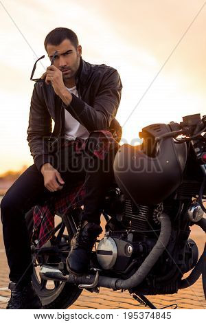 Brutal Man Sit On Cafe Racer Custom Motorbike.