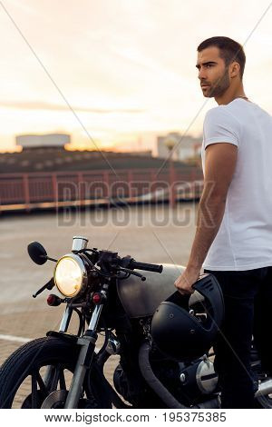 Brutal Man Near His Cafe Racer Custom Motorbike.
