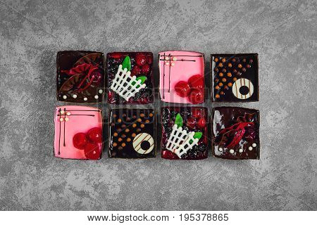 Different pastries tasty assortment. Dessert tray assorted top view background. Cakes, bright, colorful pastry sweets with fresh berries. French Bakery pattern.