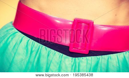 Woman fahion accessories clothing concept. Close up of pink belt on blue turquoise tulle skirt