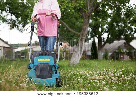 Closeup of grassmower moving on the grass