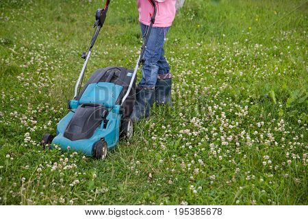 Closeup of grassmower moving on the grass