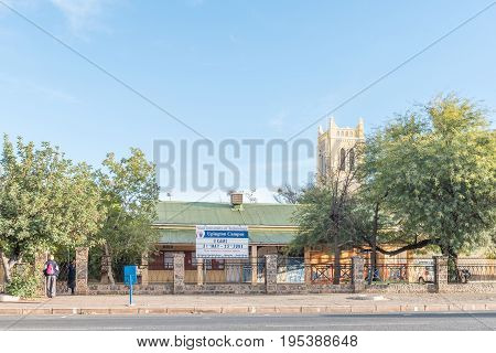 UPINGTON SOUTH AFRICA - JUNE 12 2017: Campus of the Vaal University of Technology in Upington with the tower of the Roman Catholic Cathedral of St Augustine in the back
