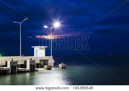 The pier that extends into the sea. Combined with a beautiful atmosphere at night.