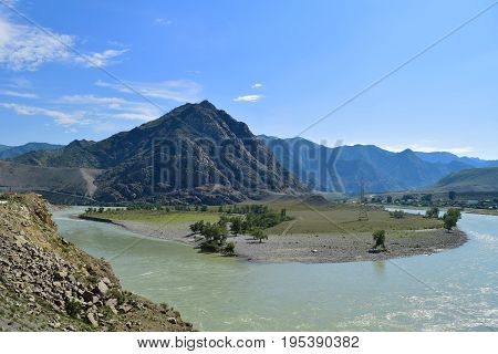 Katun river flows near countryside in Altai mountains. Altay Republic Siberia Russia.