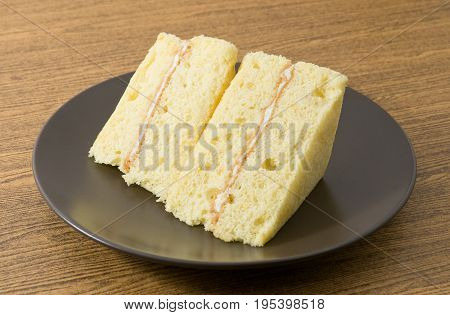 Snack and Dessert Vanilla Chiffon Cake Made With Butter Eggs Sugar Flour Baking Powder and Flavorings on White Dish.