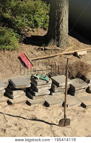 a Pavior at work: stacked tiles and equipment