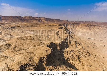 A mountain range in the Negev desert at the foot of the walls of the fortress of Masada.