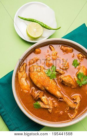 Indian spicy Chicken curry or masala chicken with prominent leg piece, popular recipe from India, selective focus