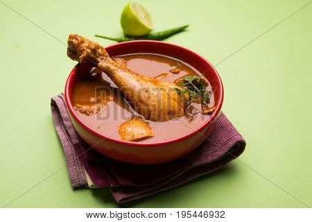 Indian spicy Chicken curry or masala chicken with prominent leg piece, popular recipe from India, selective focus