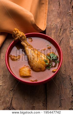 Indian spicy Chicken curry or masala chicken with prominent leg piece, popular recipe from India, selective focus