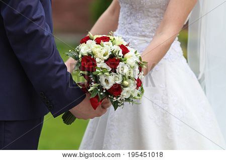 Bride and groom with bridal bouquet Close up